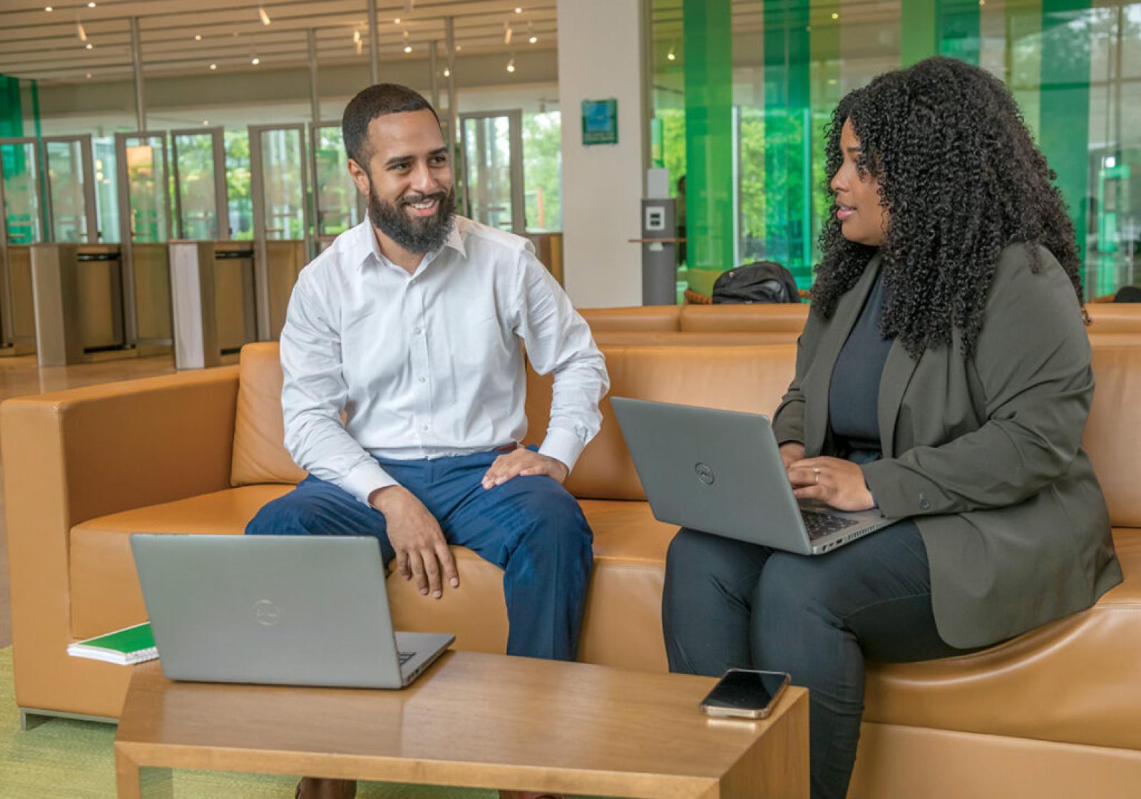  Citizens Bank employees Johnny Perez, left, assistant vice president and scrum master, and Stephanie Cuevas, social media community manager, both came up through Year Up Inc.’s career development program.  PBN PHOTO/MICHAEL SALERNO