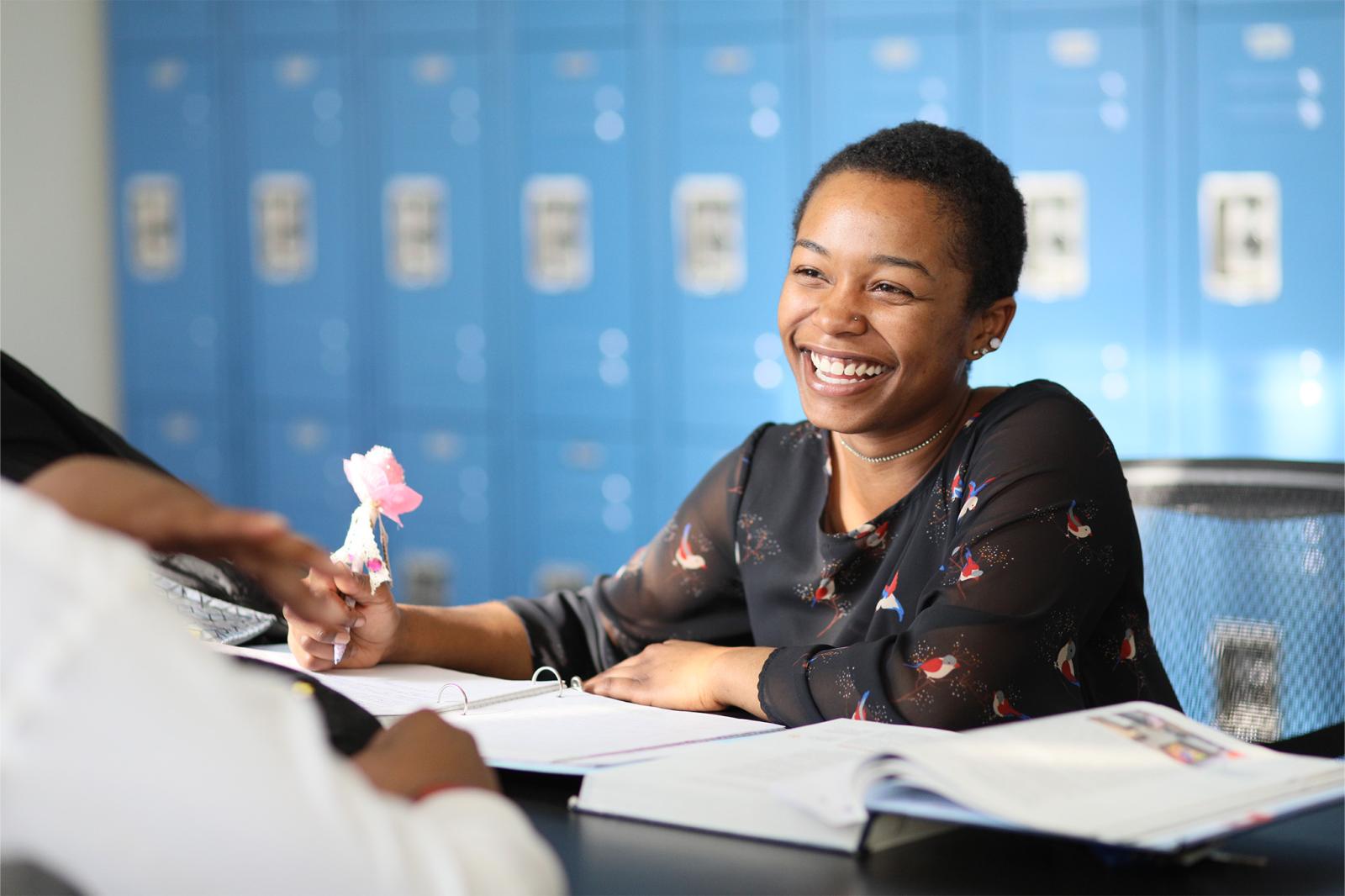 student sitting and smiling