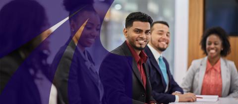 Group of young adults at conference table smiling