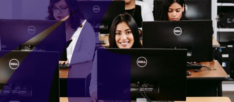 Woman at desk smiling while on computer